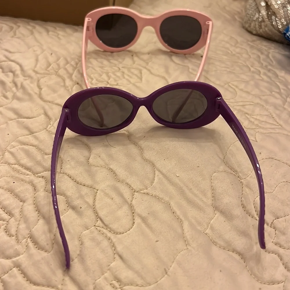 Two little girls sunglasses used in good shape pink and purple